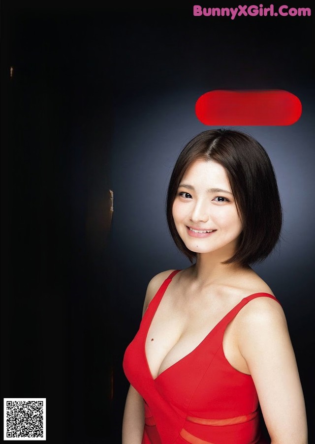 A woman in a red dress posing for a magazine cover.