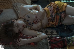A woman laying on a bed with her legs up in the air.