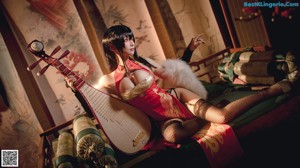 A woman in a red and black outfit playing a musical instrument.