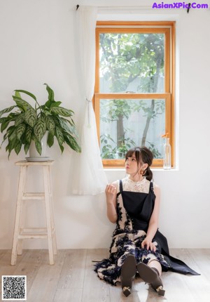 a woman sitting on top of a wooden chair