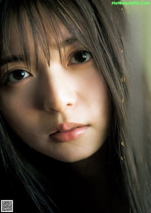 A close up of a woman with long black hair.