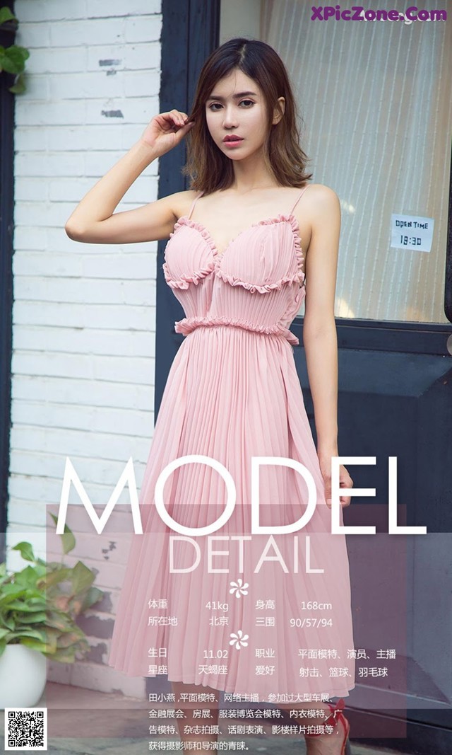 a woman in a pink dress standing in front of a door