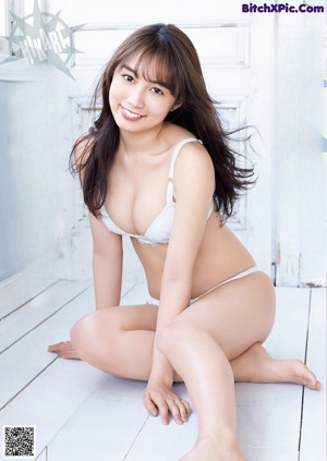 A woman in a striped shirt is posing for a picture.