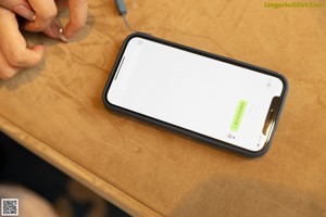 A person holding a cell phone with a message on the screen.