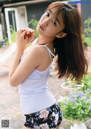 A woman with long brown hair is posing for a picture.