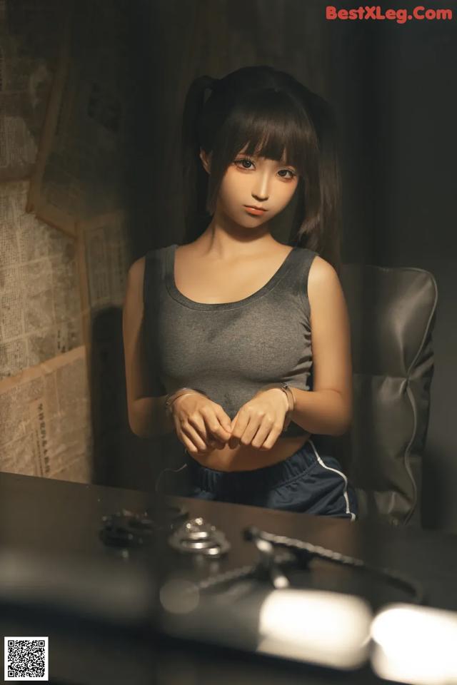 A woman sitting at a desk in front of a computer.