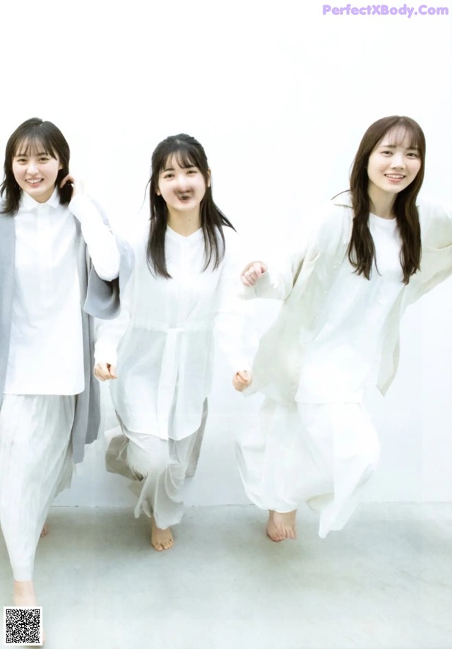 A group of three young women standing next to each other.