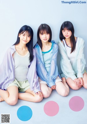 A group of young women holding colorful balloons in their hands.