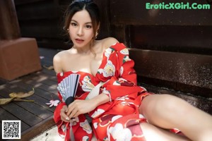 a woman in a red kimono posing for the camera